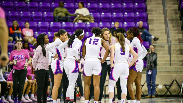 TCU Women's Basketball huddle up courtside